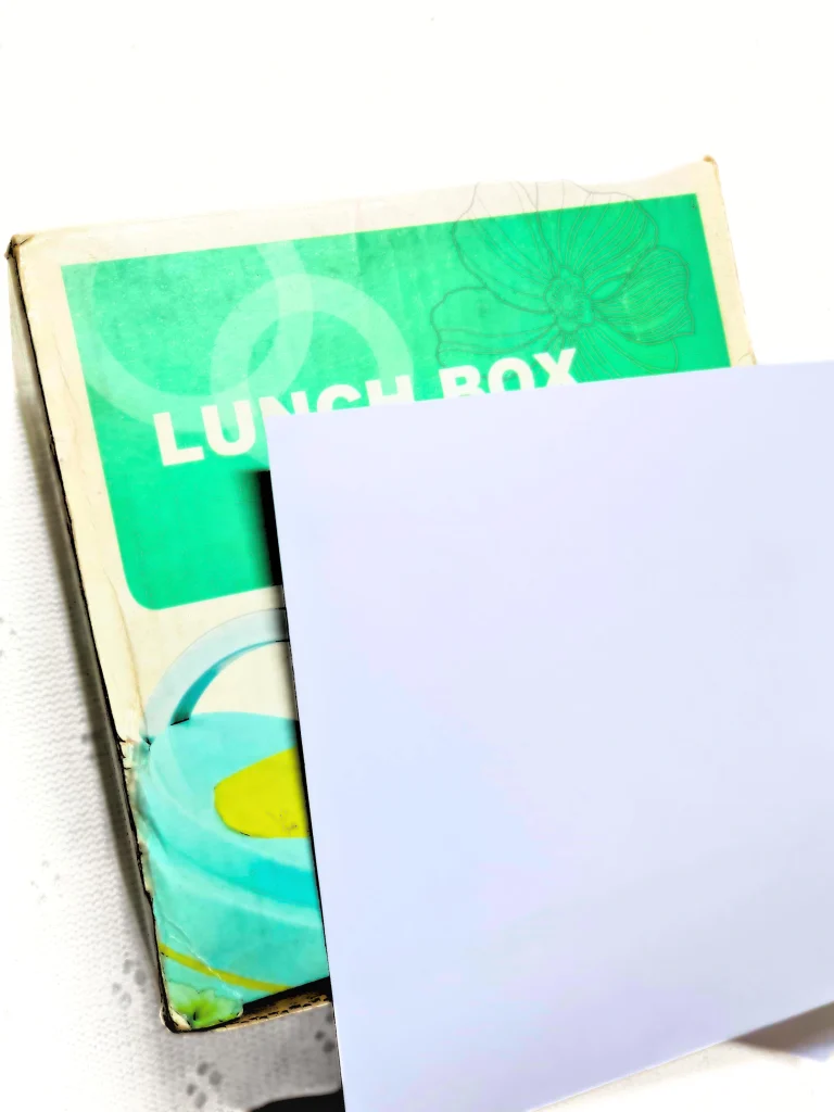 a cardboard box is about to be covered by a white paper