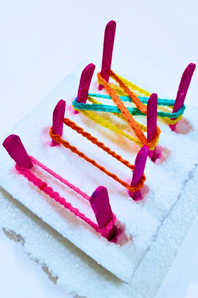 DIY geoboard using styrofoam base and popsicle sticks