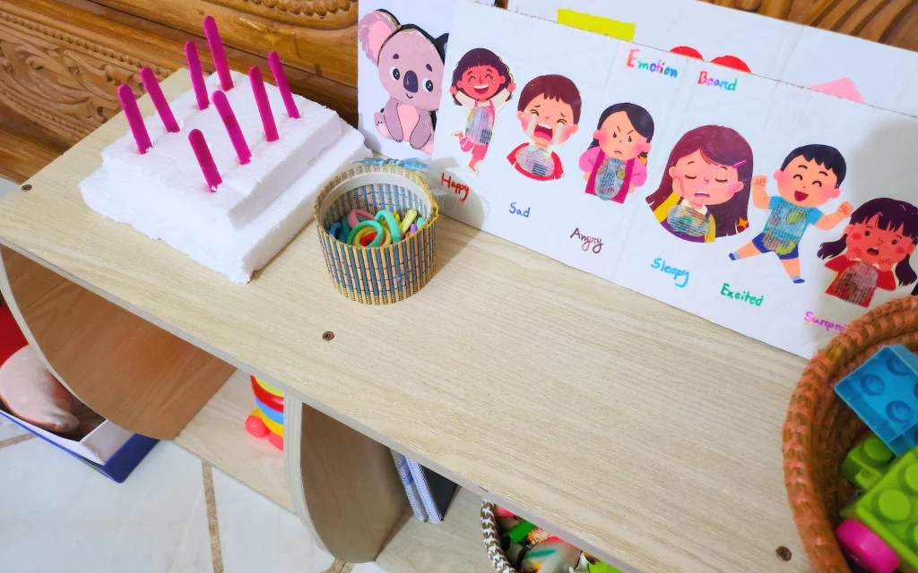 toys along with a diy geoboard is placed on a wooden shelf
