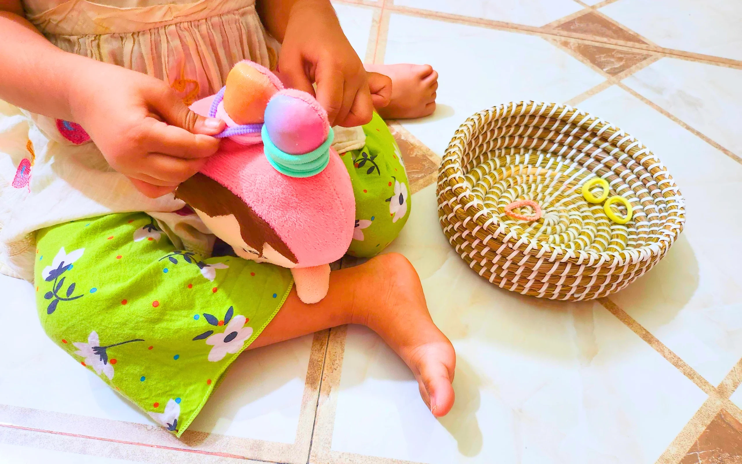 a toddler tying hair bands in a stuffie