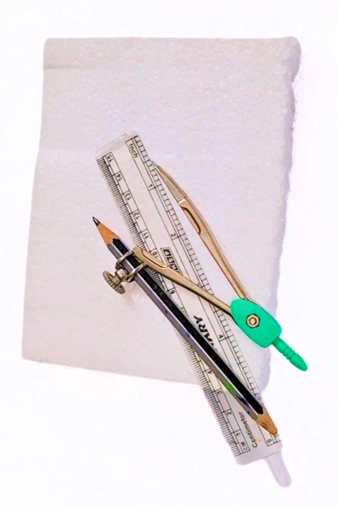styrofoam with pencil compus