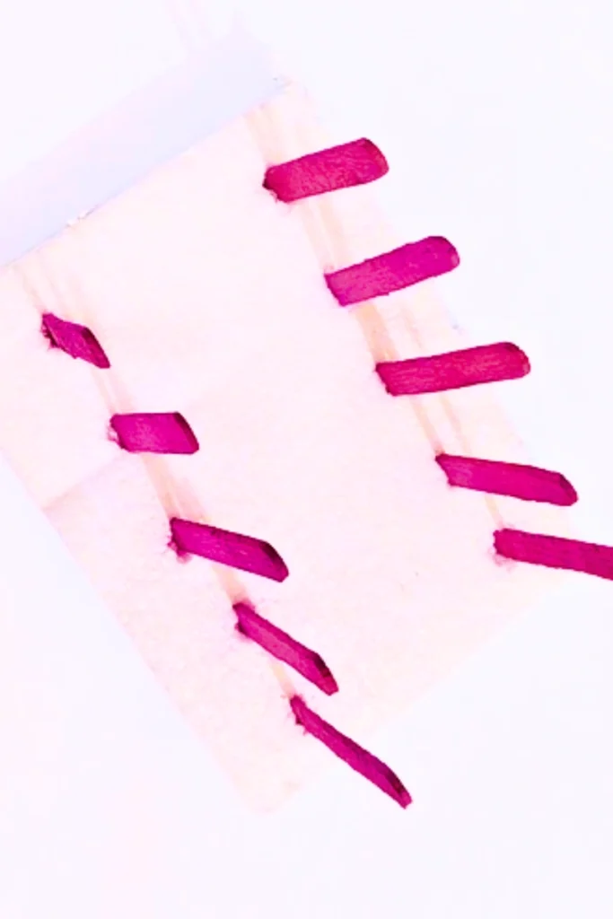 popsicle sticks are inserted upright on the styrofoam base